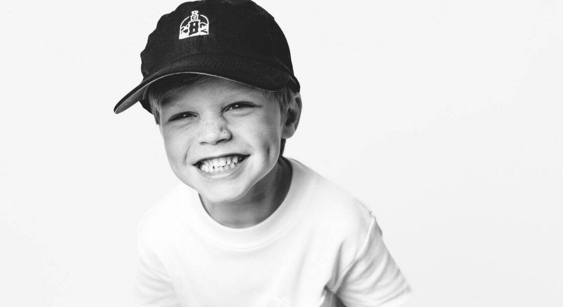 Child smiling in William L. Edwards Dentistry hat for family dental care in Rome GA